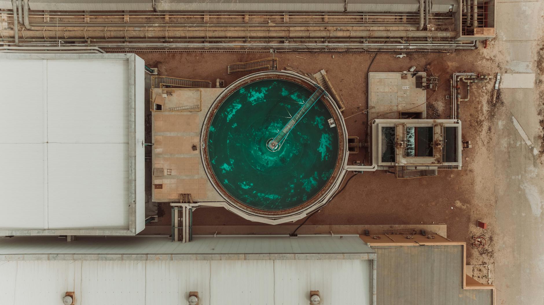 Bird's-eye view of an industrial facility in Libya featuring a circular green tank.