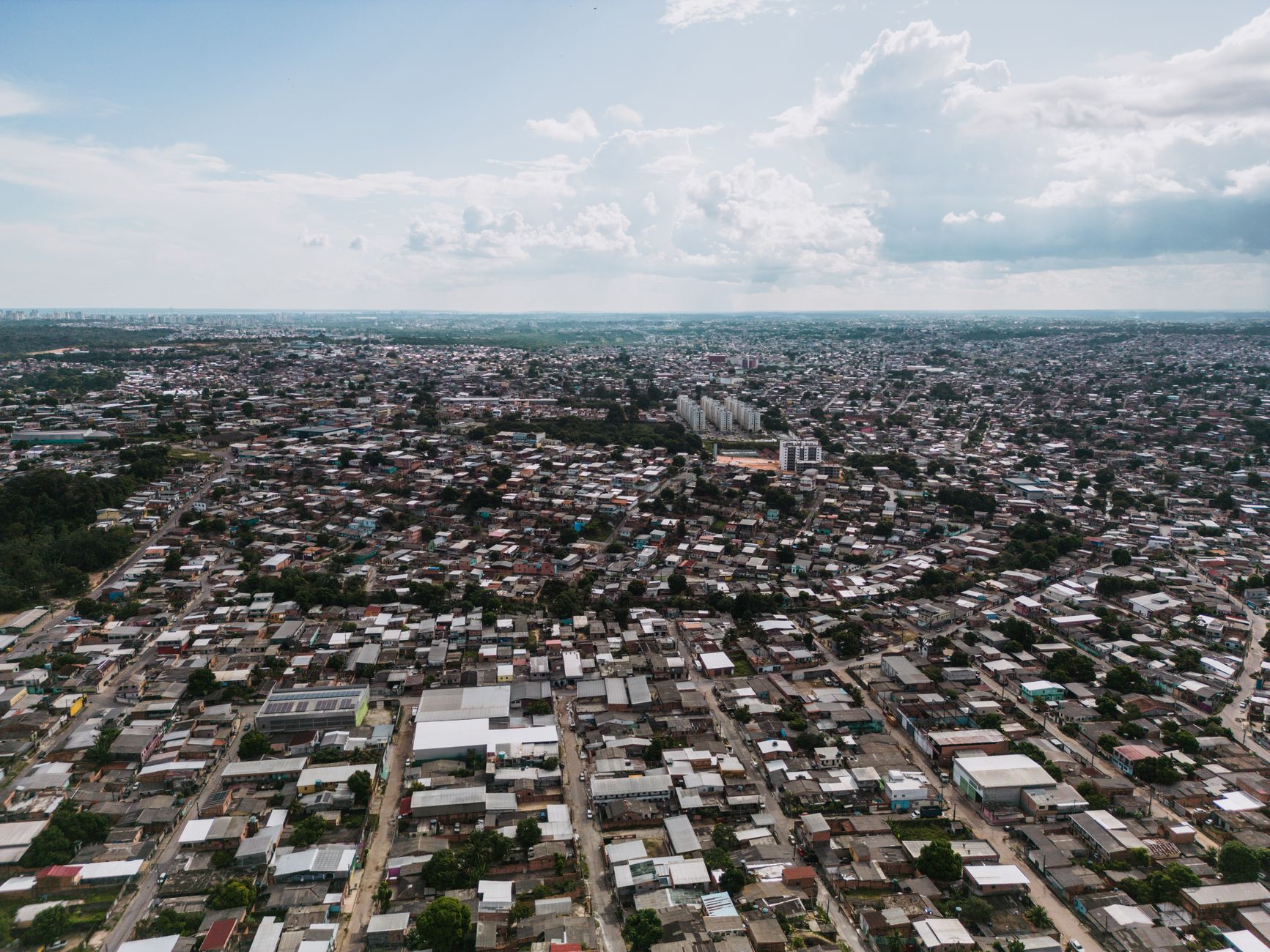 Expansive aerial view of São José Operário, showcasing dense urban architecture in Manaus, Brazil.