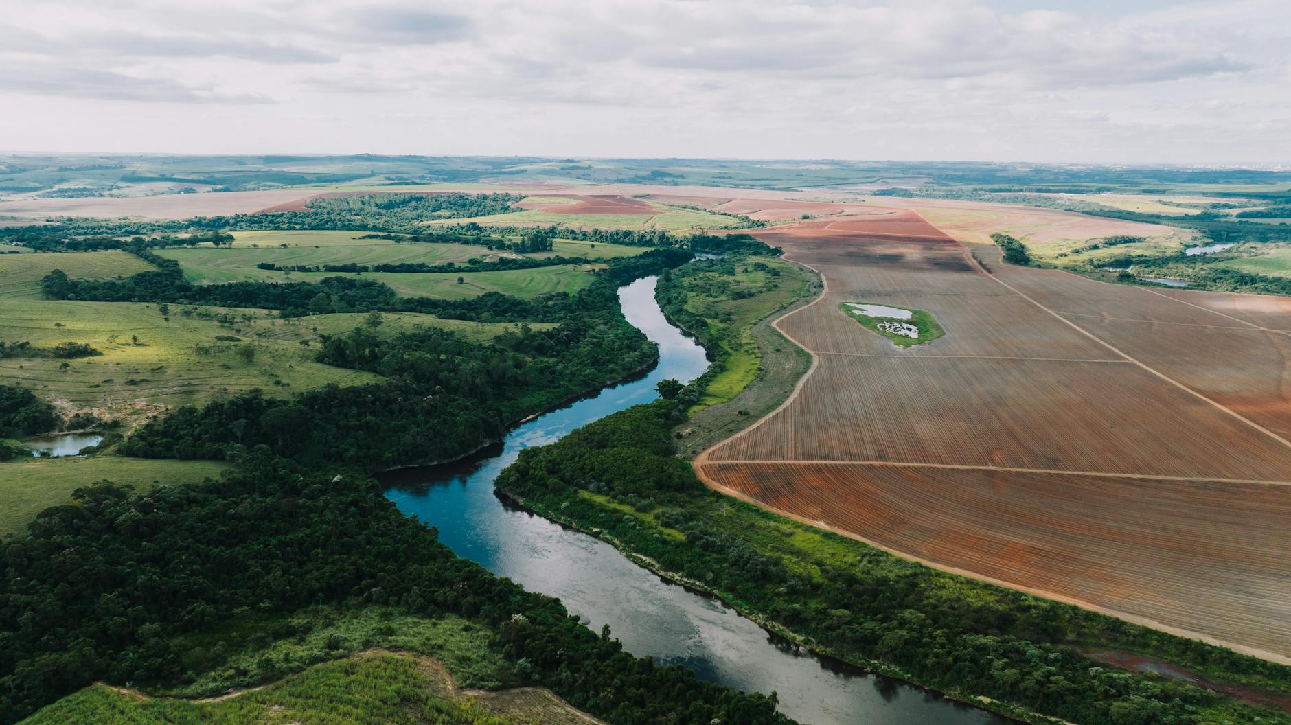 Stunning aerial view of the lush landscape and river in Porto Feliz, Brazil.