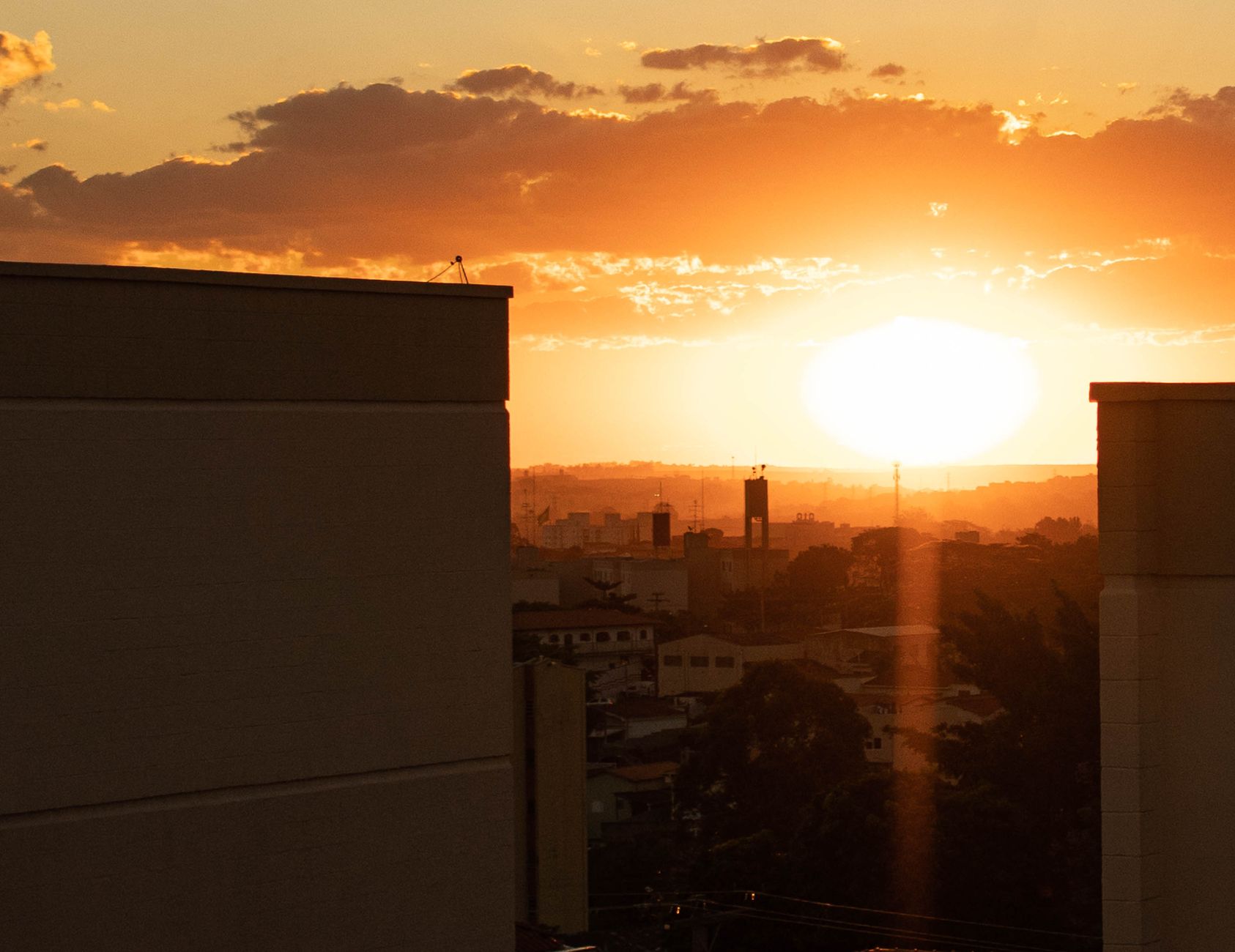 Captivating sunset over city skyline with vibrant orange hues during golden hour.