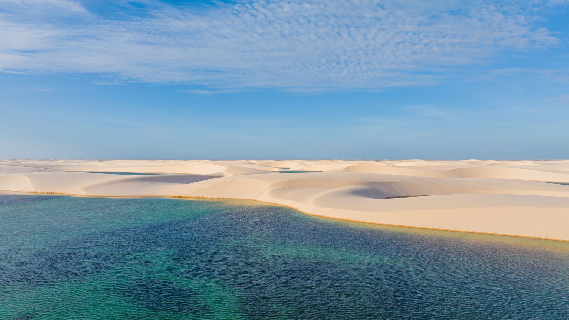 Vast sand dunes and vibrant lagoons in Lencois Maranhenses, Brazil.