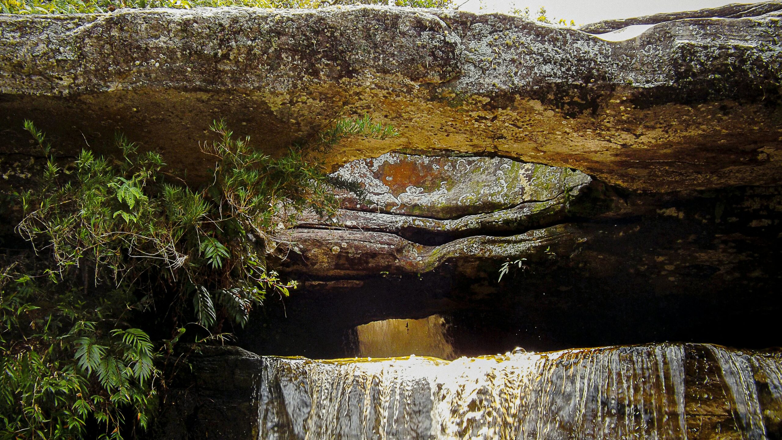 brown rock formation near body of water during daytime