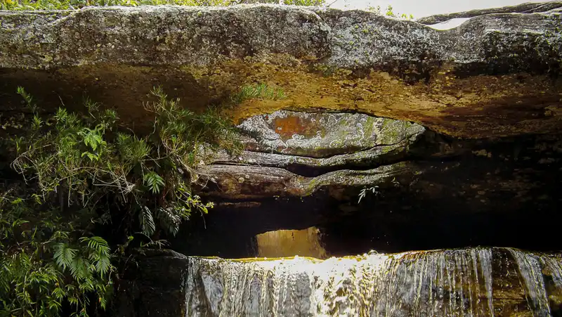 brown rock formation near body of water during daytime