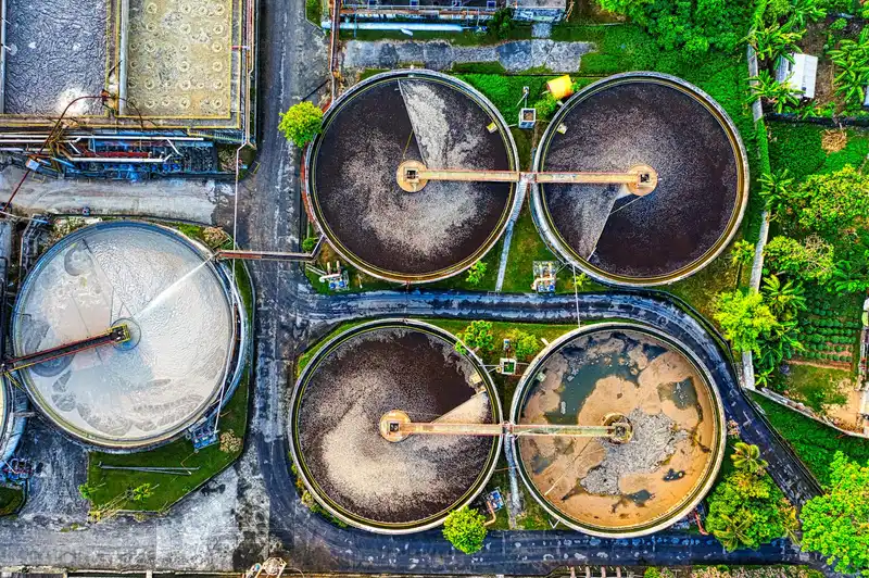 Aerial shot of a water treatment plant in Serang, Indonesia with circular tanks.