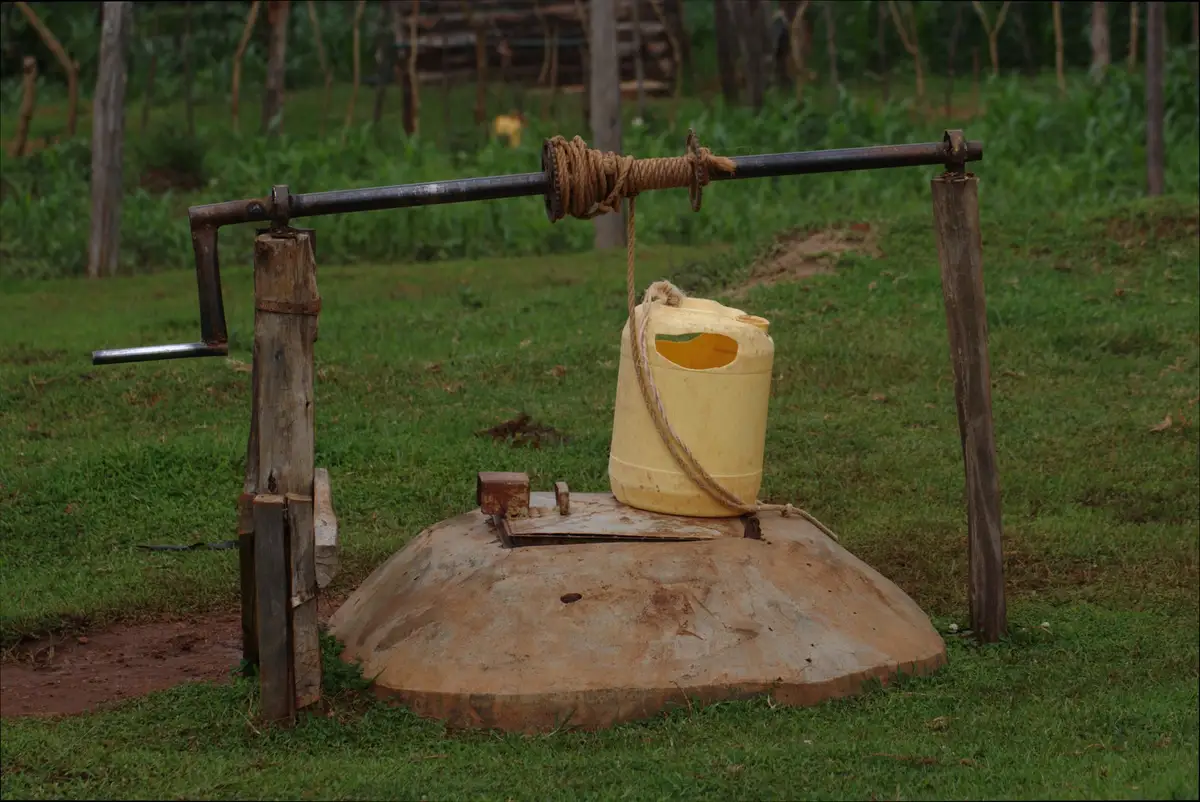 Rustic well with a yellow container in rural Kitale, Kenya.